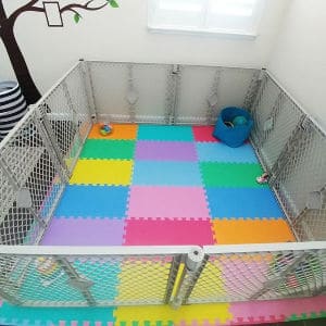 Colorful play mat with play yard to create infant space 